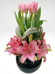 Nuestro orgullo! .... Arreglo floral de tulipanes rosas y lilis rosas que dejará sin palabras y causará una enorme emoción a quien lo practicó!. Especificaciones del Arreglo: Follaje, Esfera de cristal color negro, Mensaje impreso, Altura promedio del arreglo: 70 cm